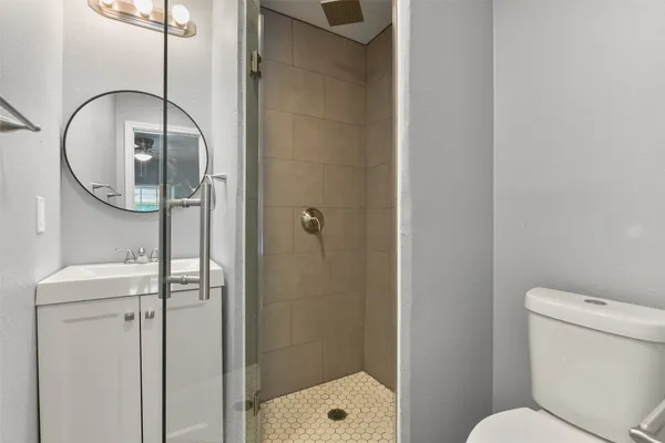 a bathroom with a toilet and a shower