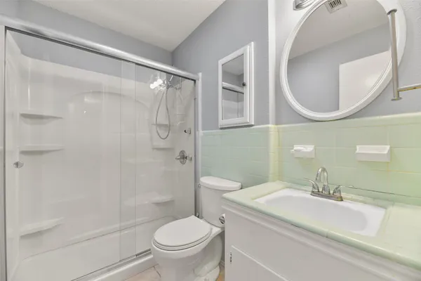 a bathroom with a sink toilet and shower