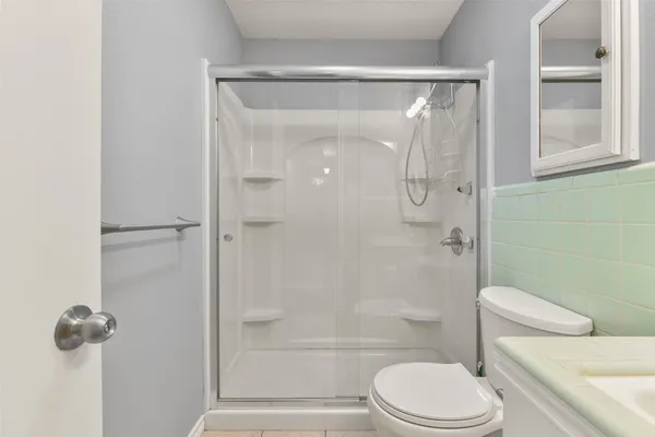 a bathroom with a toilet and shower