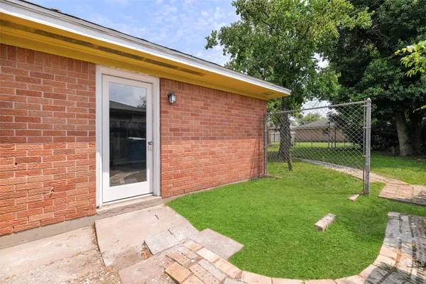 a backyard of a house with swimming pool and trees