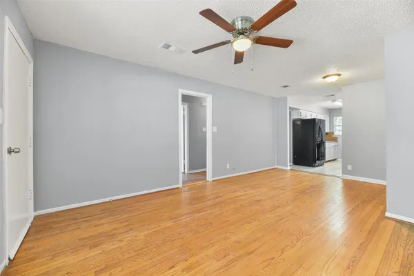 a view of an empty room with a ceiling fan