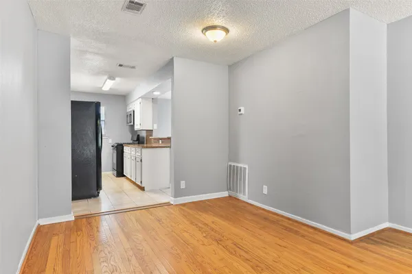 a view of a kitchen cabinets and wooden floor