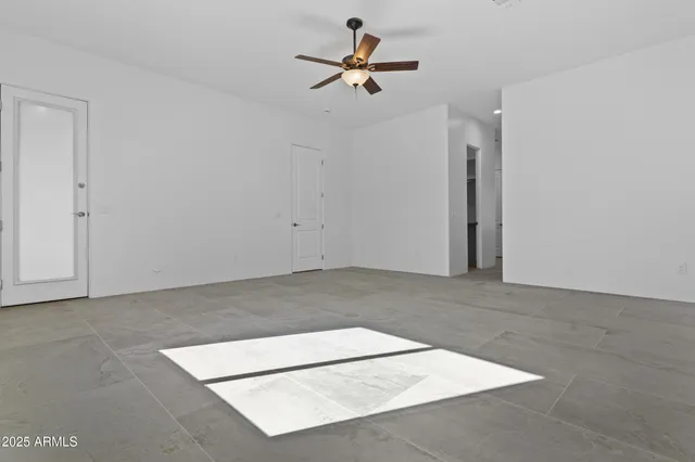 an empty room with windows and closet