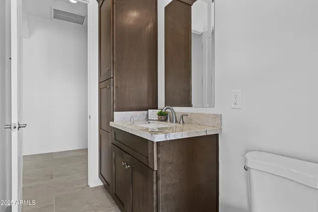 a kitchen with stainless steel appliances granite countertop wooden cabinets and sink
