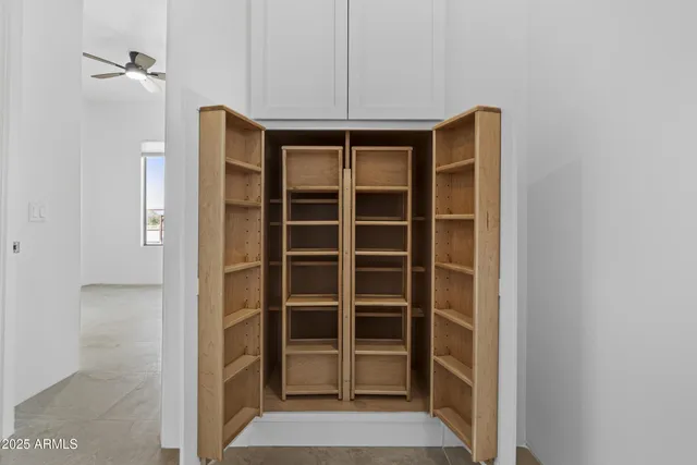 a kitchen that has a lot of cabinets in it with granite countertop stainless steel appliances