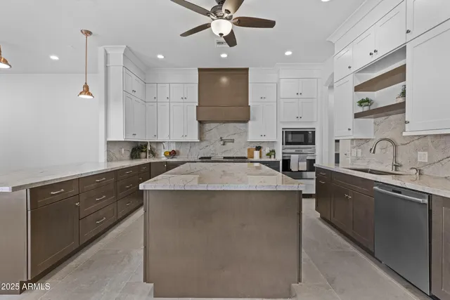 a kitchen with a counter space a sink appliances and cabinets