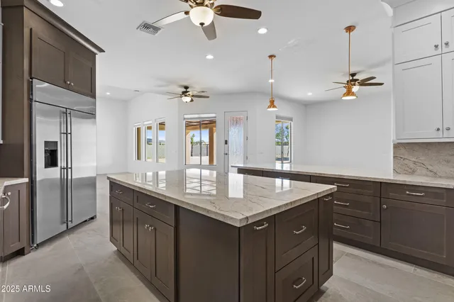 a living room with furniture kitchen view and a flat screen tv