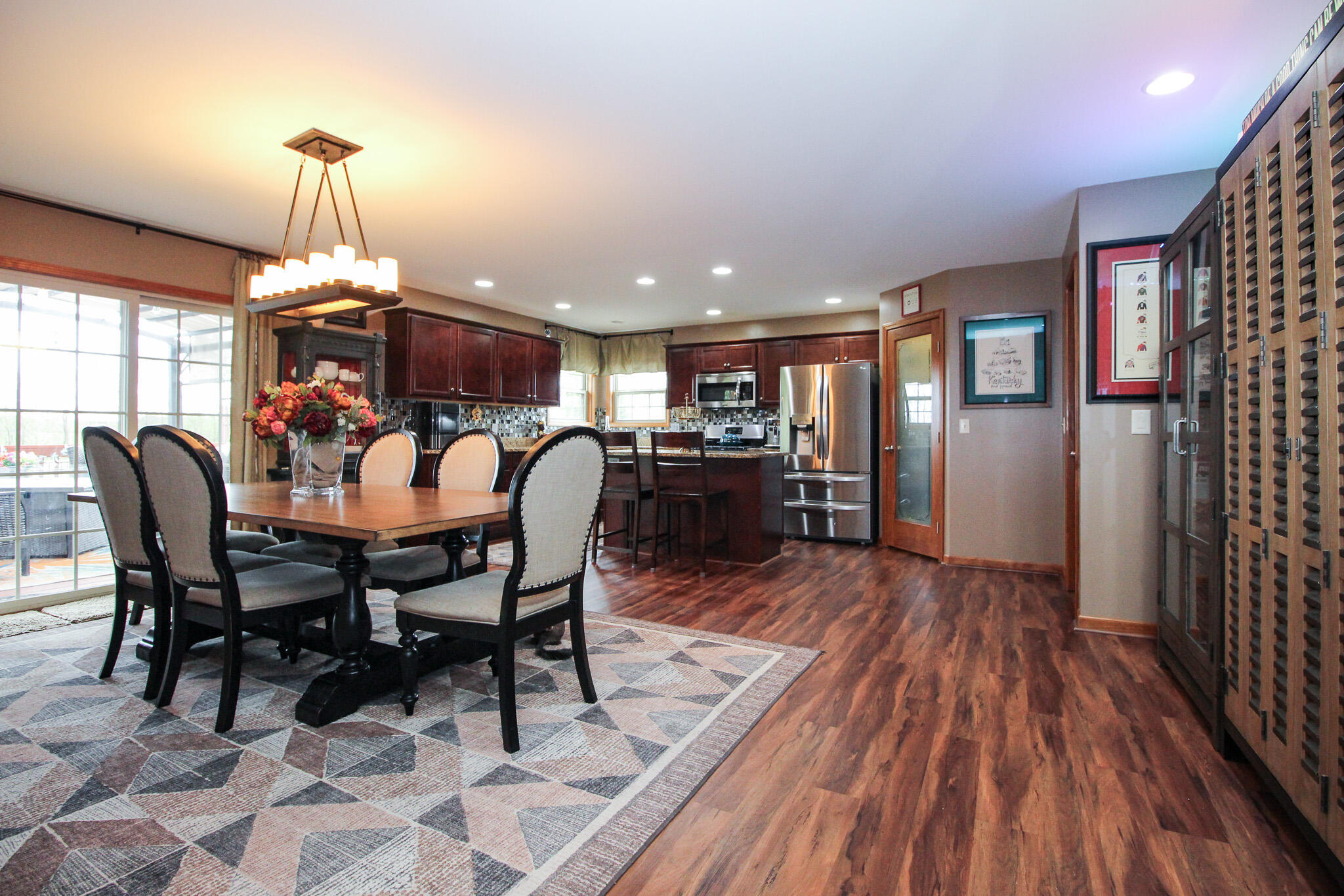 2913 Cardinal Drive Wheatfield, IN 46392 - Photo 9 of 34 a dining room with furniture a chandelier and wooden floor