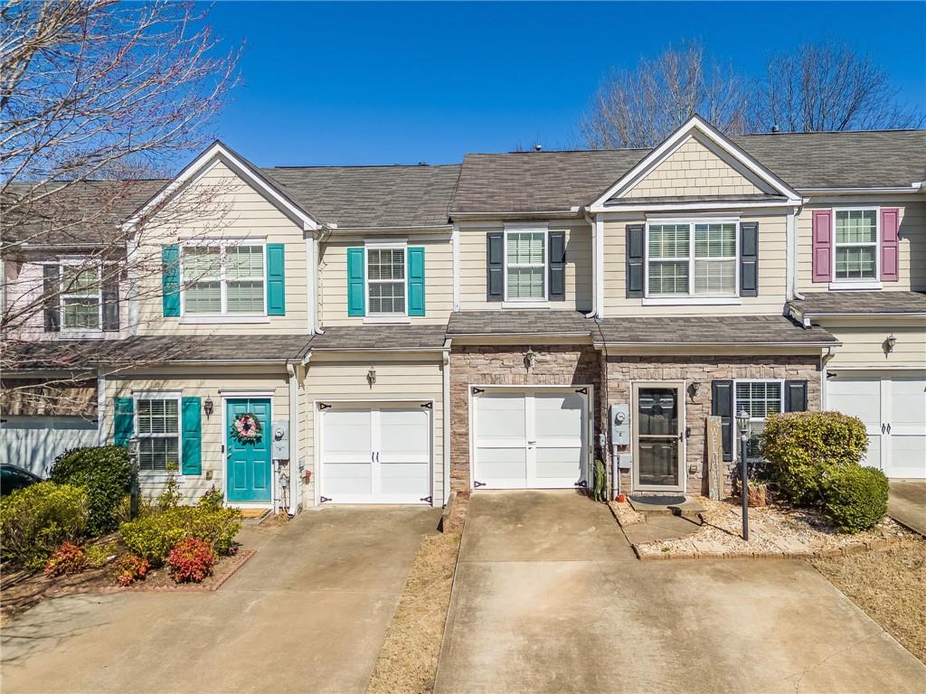 820 Ash Street Canton, GA 30114 - Photo 1 of 1 a front view of a house with a yard and garage