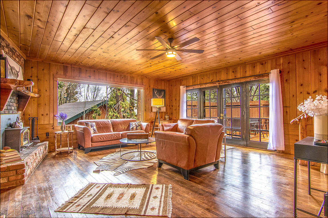 25455 Lodge Road Idyllwild, CA 92549 - Photo 2 of 95 a living room with furniture a large window and wooden floor
