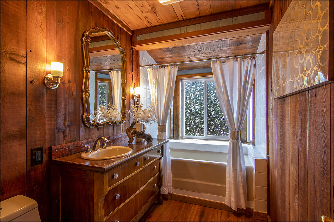 25455 Lodge Road Idyllwild, CA 92549 - Photo 31 of 95 a bathroom with a sink a mirror and a shower