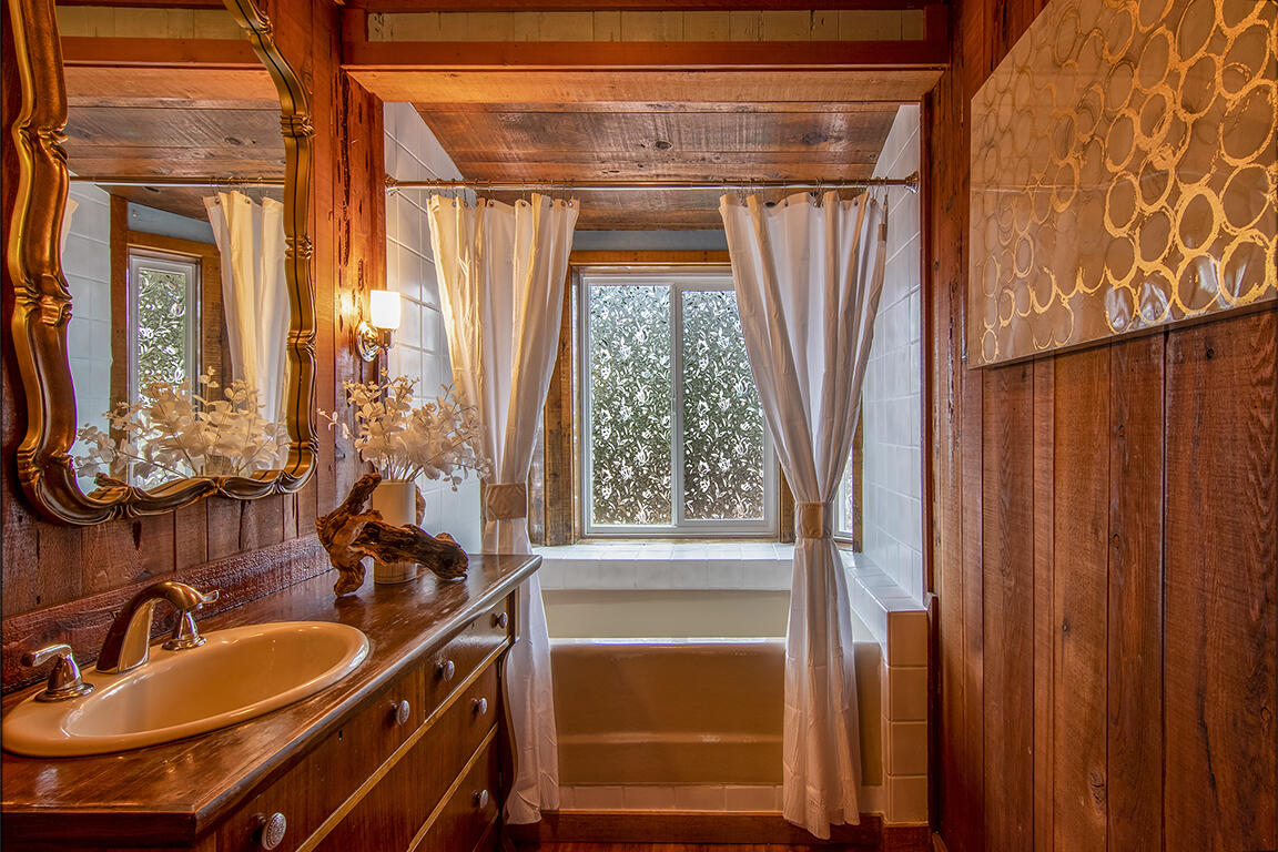 25455 Lodge Road Idyllwild, CA 92549 - Photo 32 of 95 a bathroom with a sink a mirror and a shower