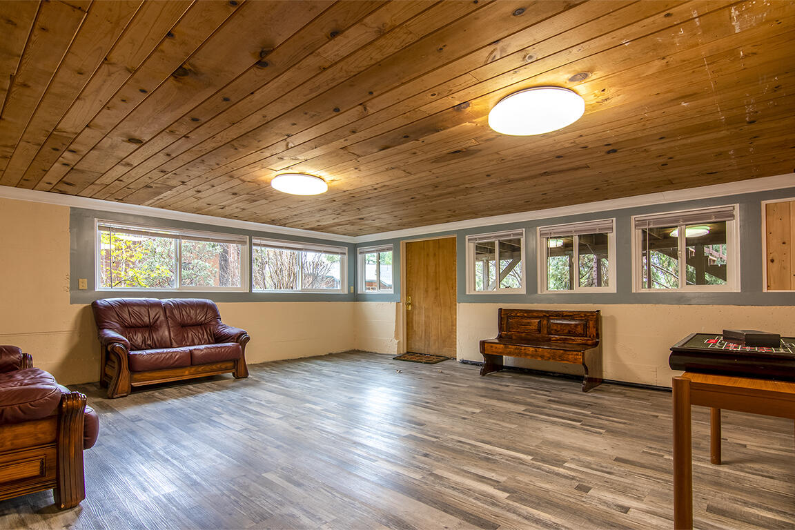 25455 Lodge Road Idyllwild, CA 92549 - Photo 38 of 95 a living room with furniture stove and wooden floor
