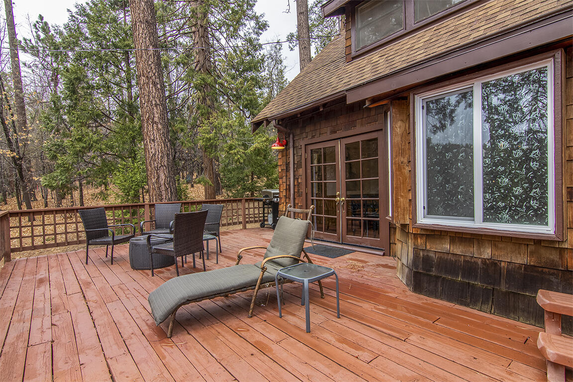25455 Lodge Road Idyllwild, CA 92549 - Photo 45 of 95 a view of a deck with table and chairs wooden floor and fence
