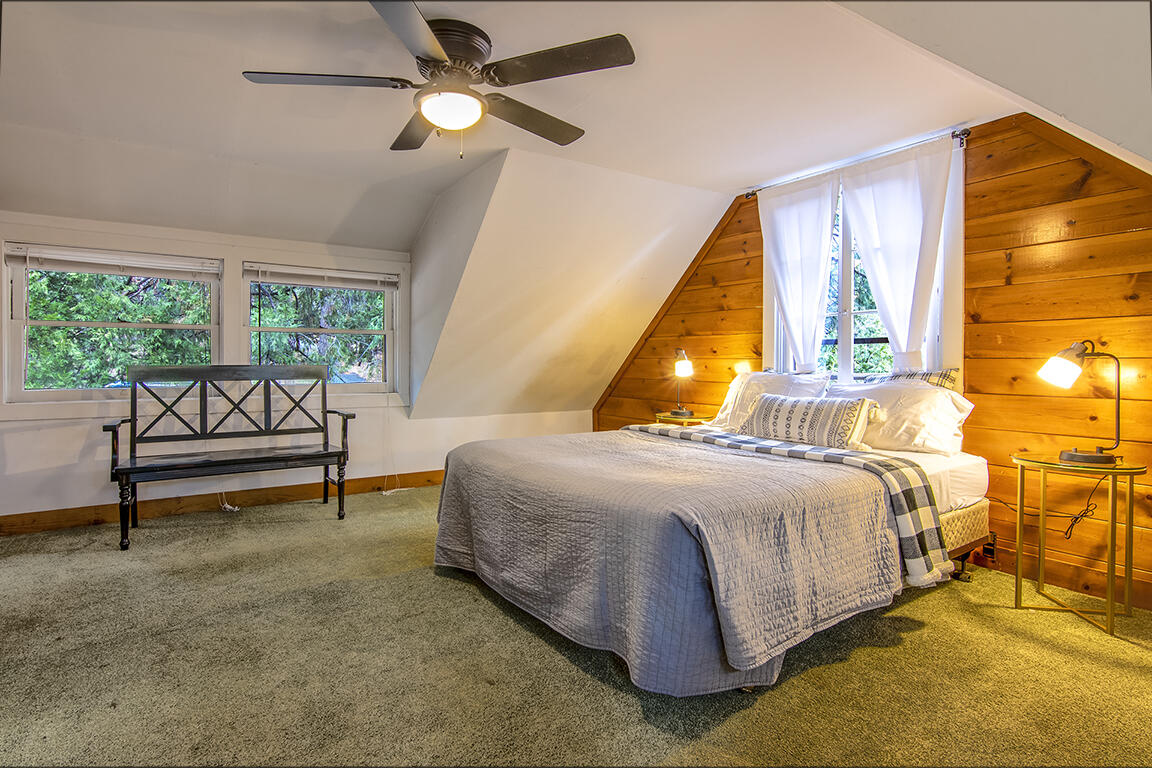 25455 Lodge Road Idyllwild, CA 92549 - Photo 54 of 95 a bedroom with a bed and a chandelier