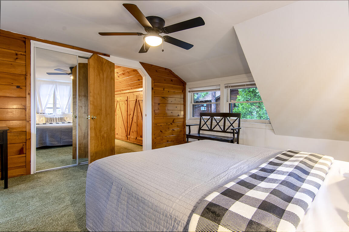 25455 Lodge Road Idyllwild, CA 92549 - Photo 55 of 95 a bedroom with a large bed and a chandelier