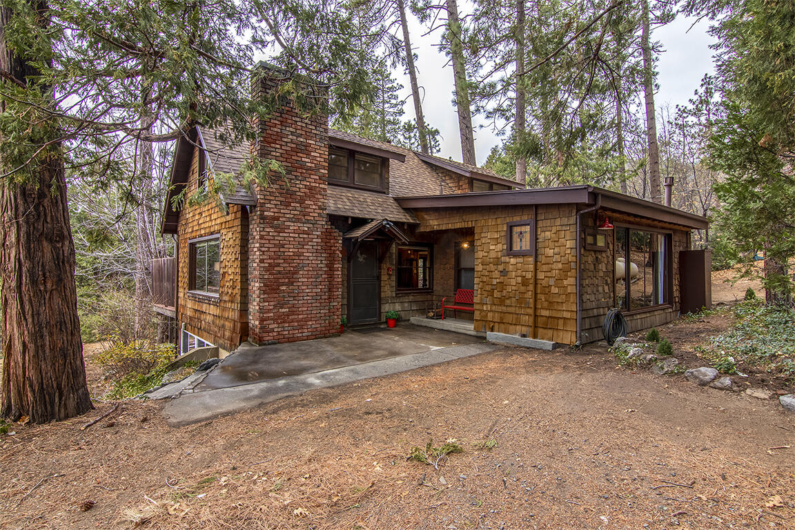 25455 Lodge Road Idyllwild, CA 92549 - Photo 79 of 95 a view of a house with a large window and large tree