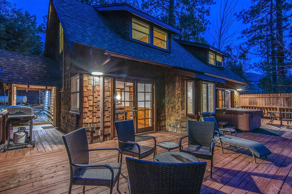 25455 Lodge Road Idyllwild, CA 92549 - Photo 94 of 95 a view of a patio with couches table and chairs and wooden floor