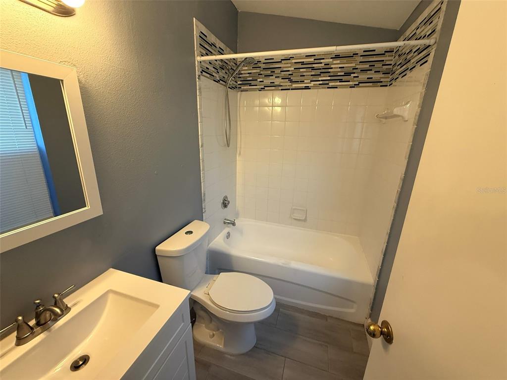1325 Lyonshire Drive Wesley Chapel, FL 33543 - Photo 16 of 20 a bathroom with a bathtub shower sink vanity and toilet