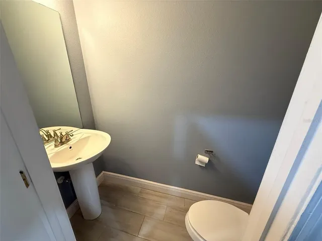 a bathroom with a sink toilet and mirror
