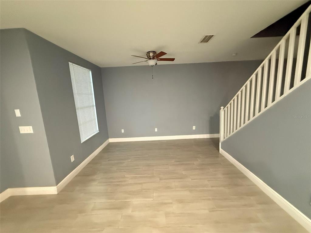 1325 Lyonshire Drive Wesley Chapel, FL 33543 - Photo 8 of 20 wooden floor in an empty room with a window