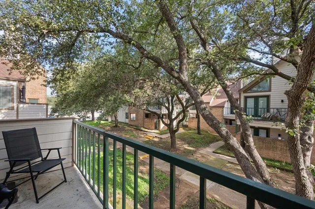 a view of a balcony with wooden fence