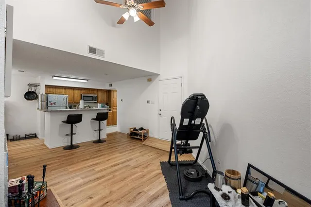 a view of a workspace with furniture and wooden floor
