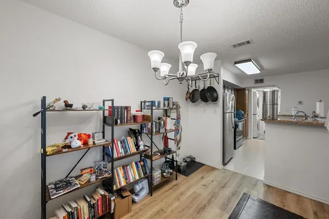 a view of a room with furniture and wooden floor