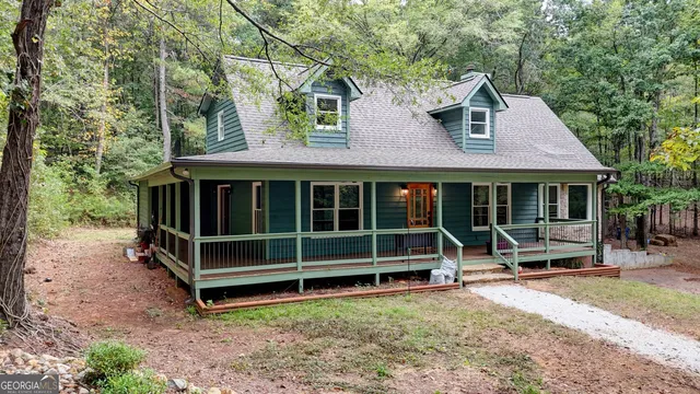 a view of a house with a yard and sitting area