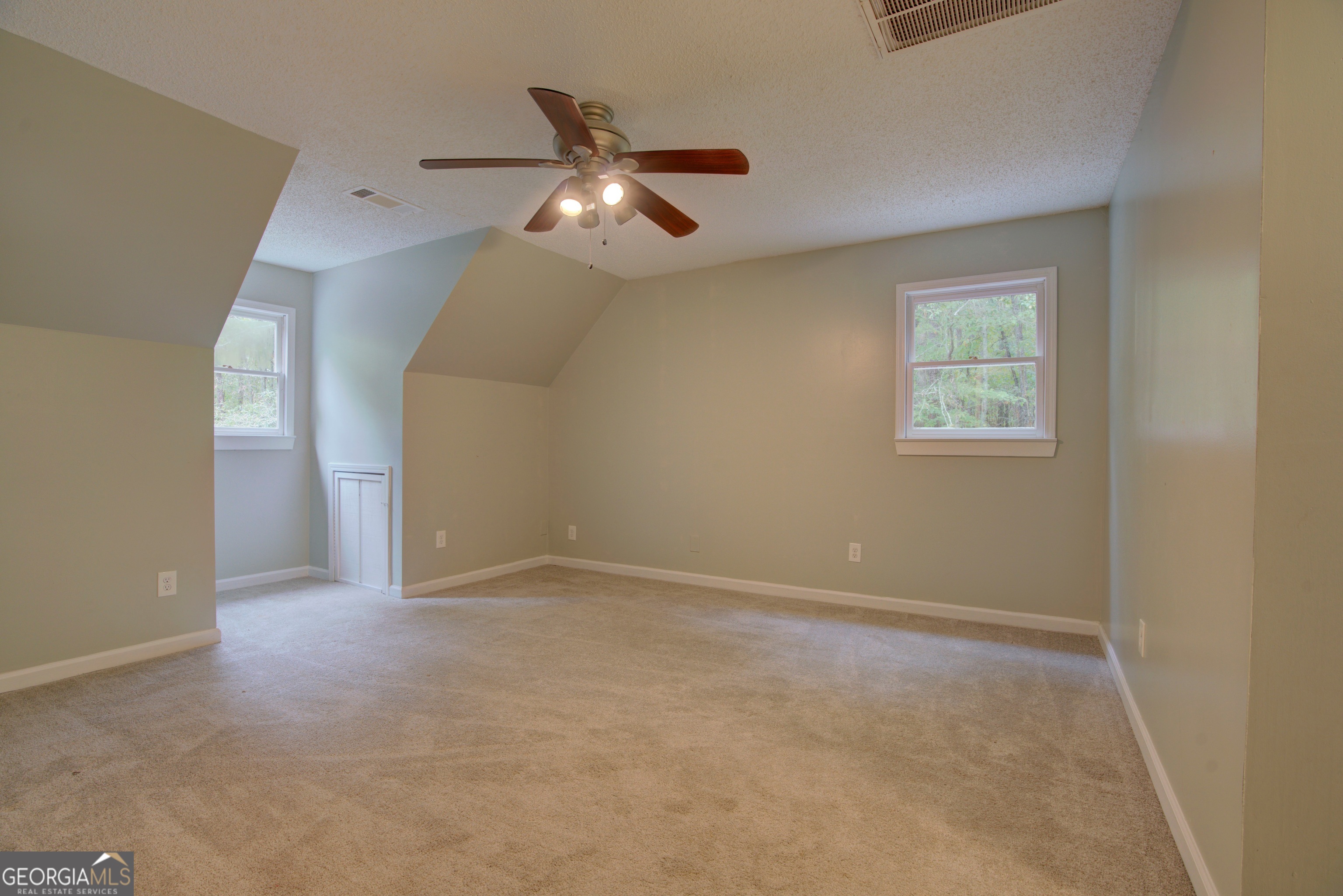 637 Wayside Road Rome, GA 30161 - Photo 26 of 40 an empty room with a chandelier fan and windows