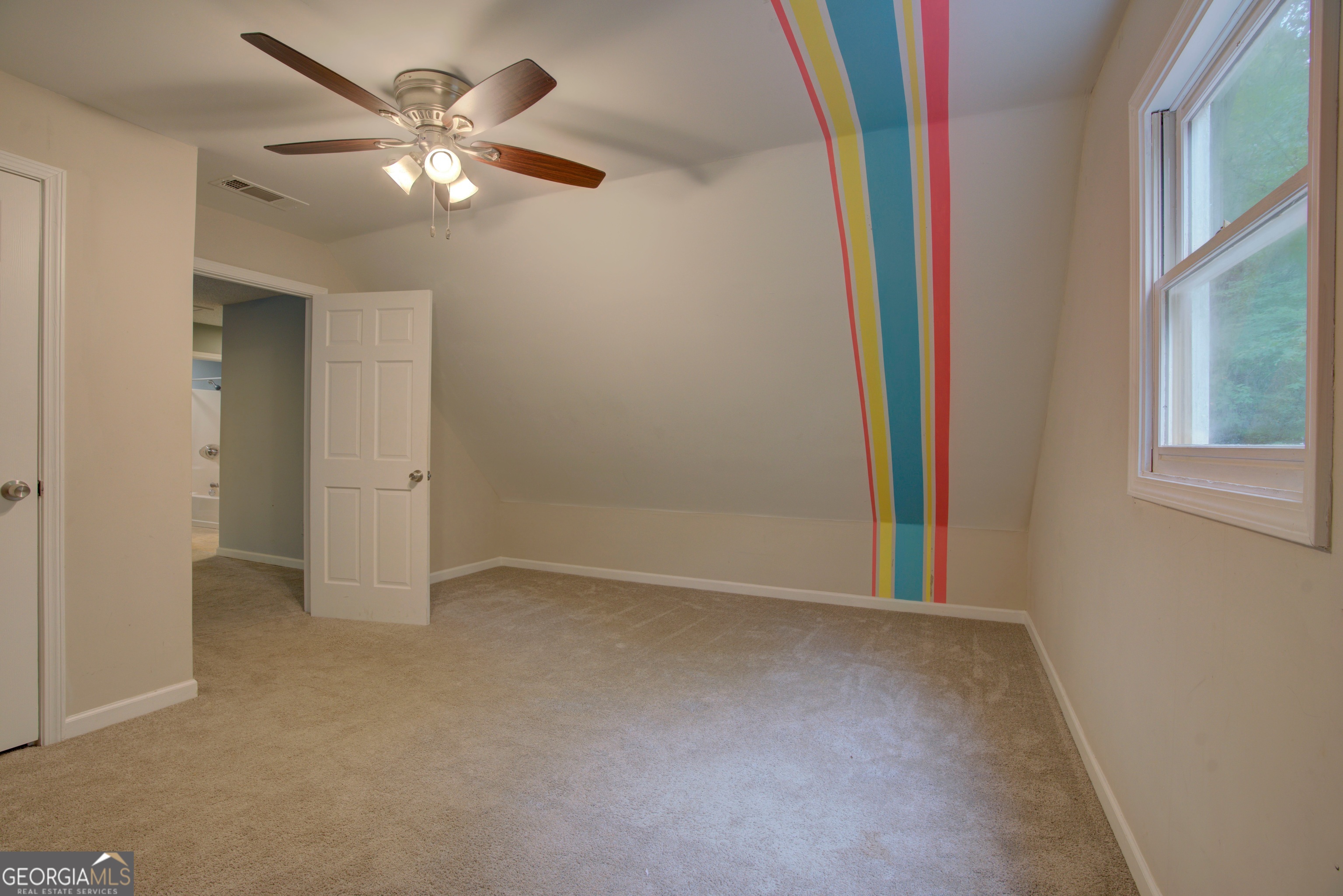 637 Wayside Road Rome, GA 30161 - Photo 34 of 40 an empty room with a chandelier fan and windows