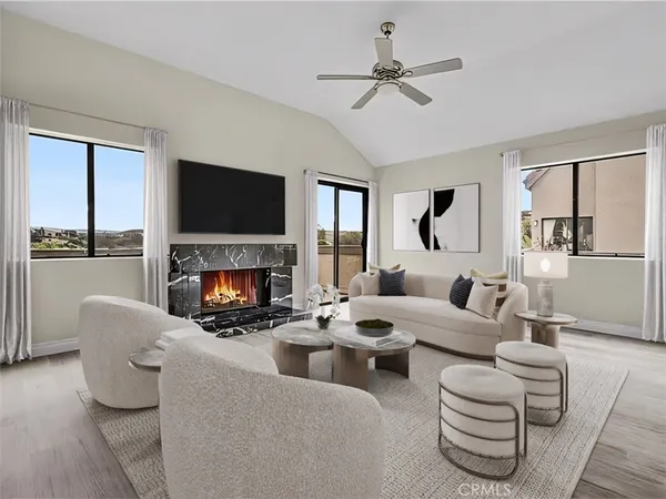 a living room with fireplace furniture and a flat screen tv