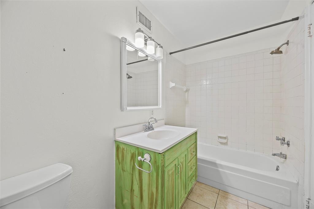 2626 Madera Street Dallas, TX 75206 - Photo 11 of 30 a bathroom with a granite countertop sink a mirror and a bathtub