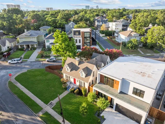 an aerial view of a house with garden space and street view