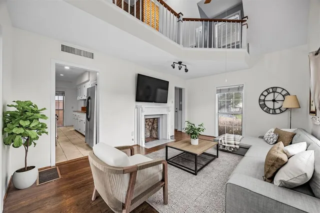 a living room with furniture a chandelier and a flat screen tv