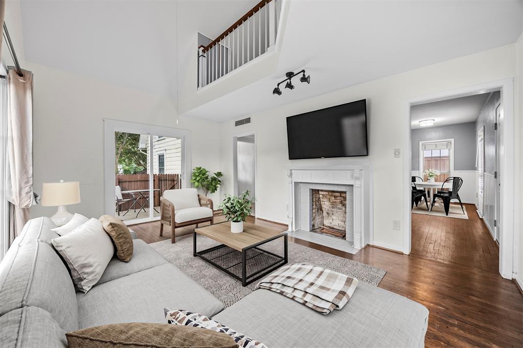 2626 Madera Street Dallas, TX 75206 - Photo 4 of 30 a living room with furniture a fireplace and a flat screen tv