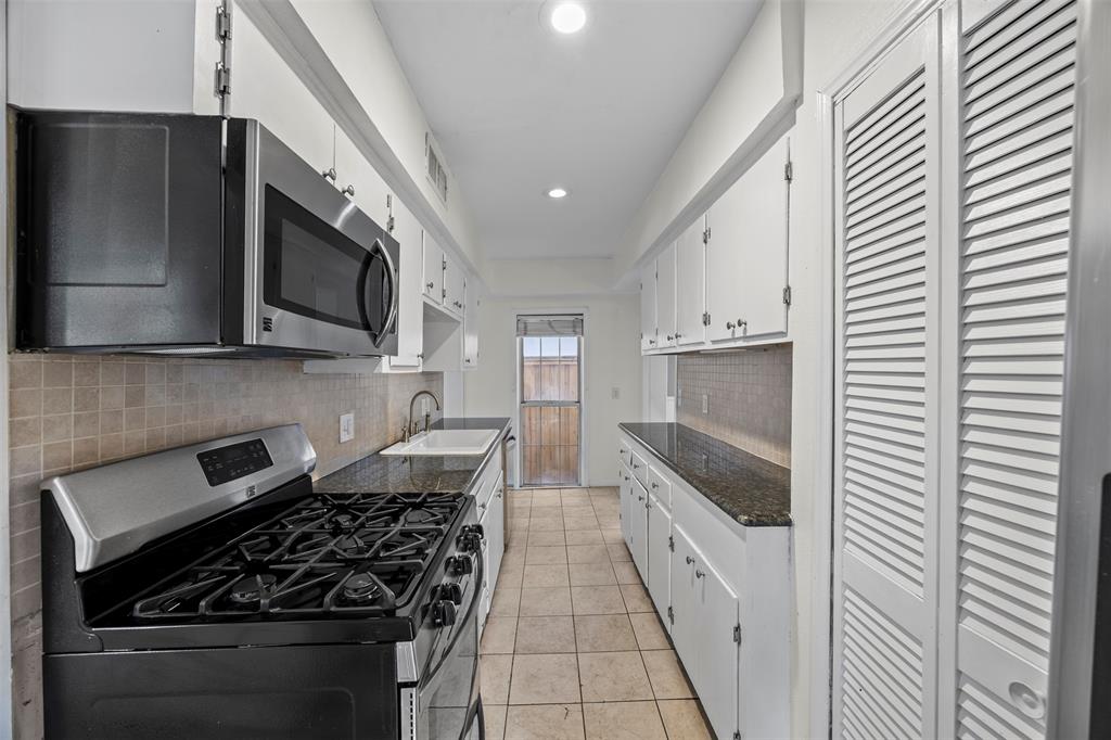2626 Madera Street Dallas, TX 75206 - Photo 7 of 30 a kitchen with stainless steel appliances granite countertop a stove and a refrigerator