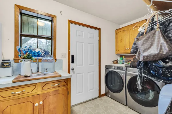 a utility room with sink dryer and washer