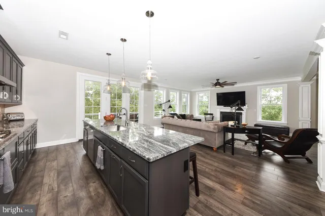 a living room with granite countertop furniture and a flat screen tv