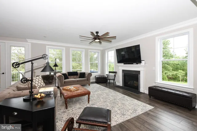 a living room with furniture fireplace and window