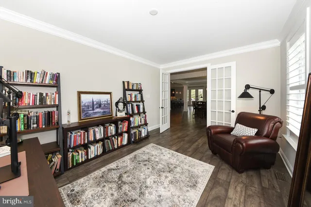 a living room with furniture a rug and a book shelf