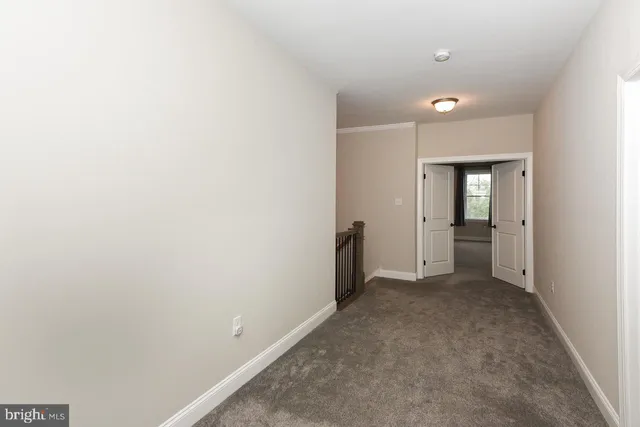 an empty room with an entrance and closet