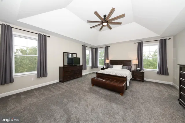 a living room with a bed furniture and a large window