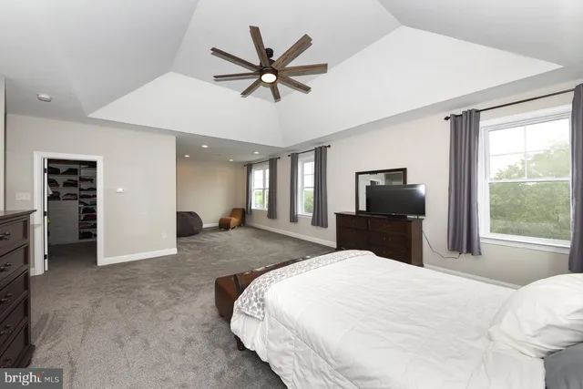 a bedroom with a large bed and a tv