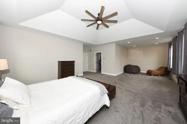 a bed room with a bed and a ceiling fan