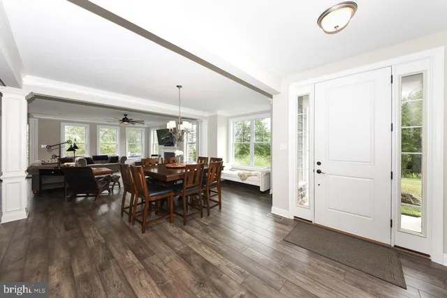 a dining room with furniture and wooden floor
