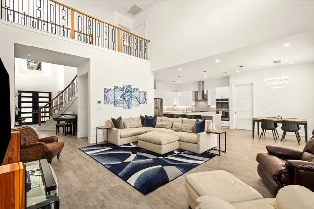 a living room with furniture wooden floor and a large window