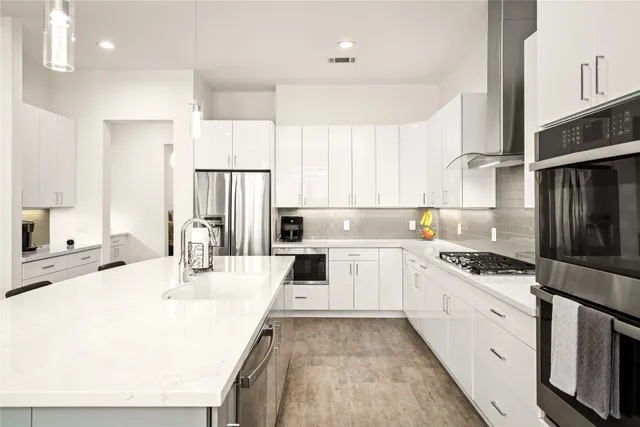 a kitchen with cabinets and chairs