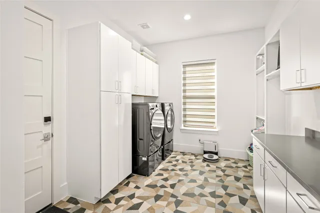 a spacious bedroom with a bed and a flat screen tv