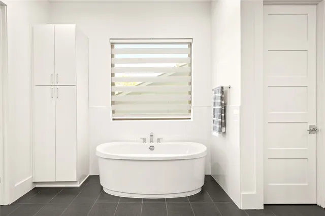 a view of walk in closet with hardwood floor